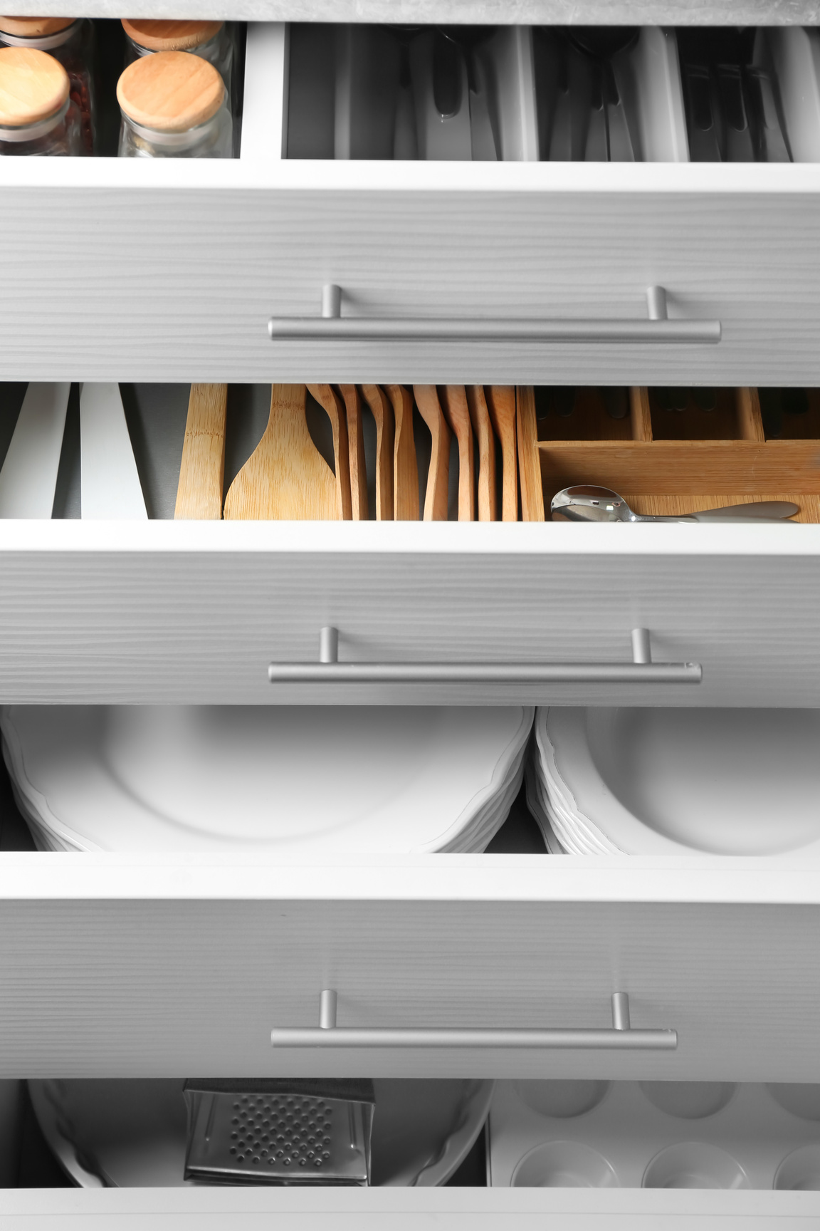 Set of Ceramic Plates and Utensils in Kitchen Drawers